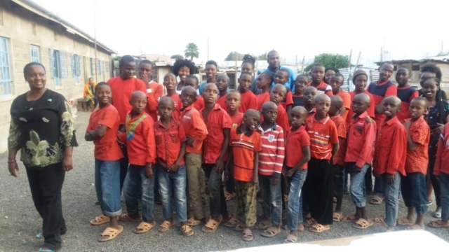 Jirani children posing for a picture with the founder Veronica Thĩga.  2016